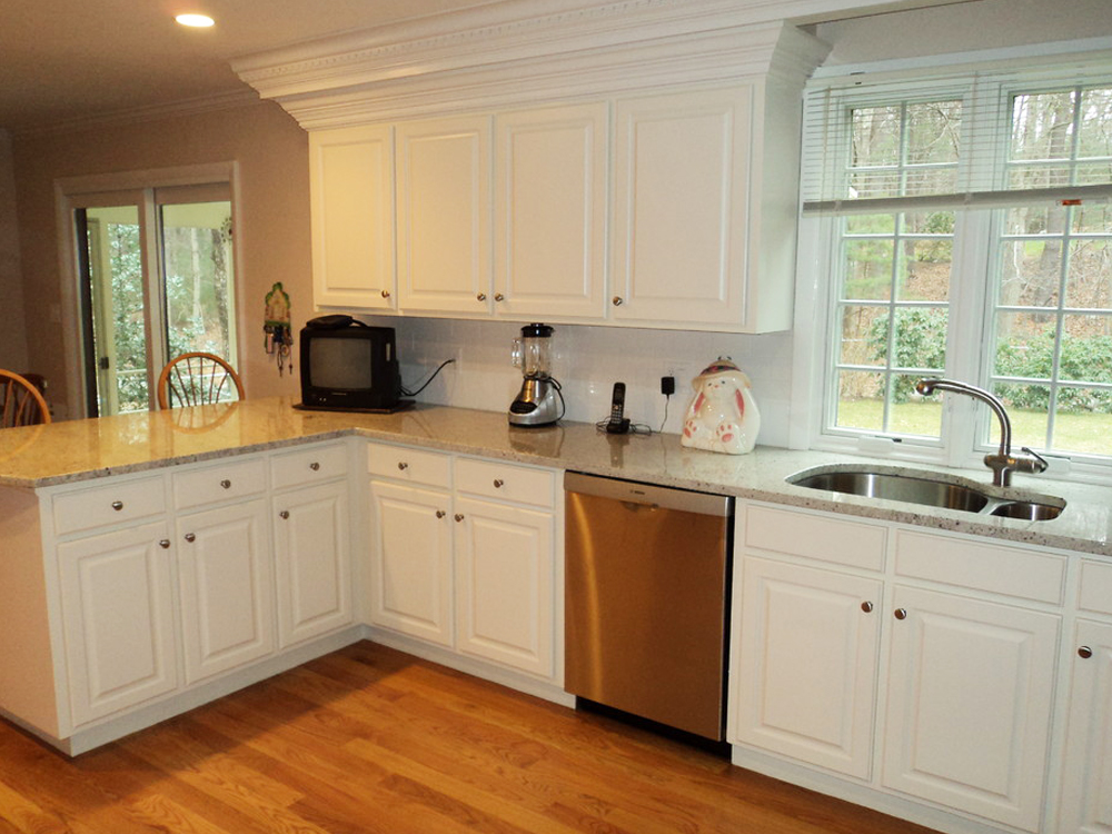 This remodel opened up the kitchen, and added a peninsula. Note how wide the peninsula is - with room for people to eat and cook at the same time. WIth the intricate, custom molding, this kitchen is beautiful!
