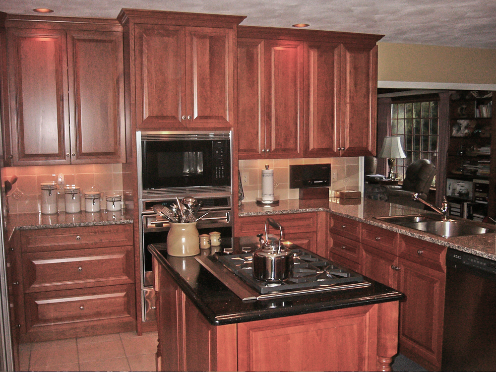 Cherry kitchen with view of island and overn