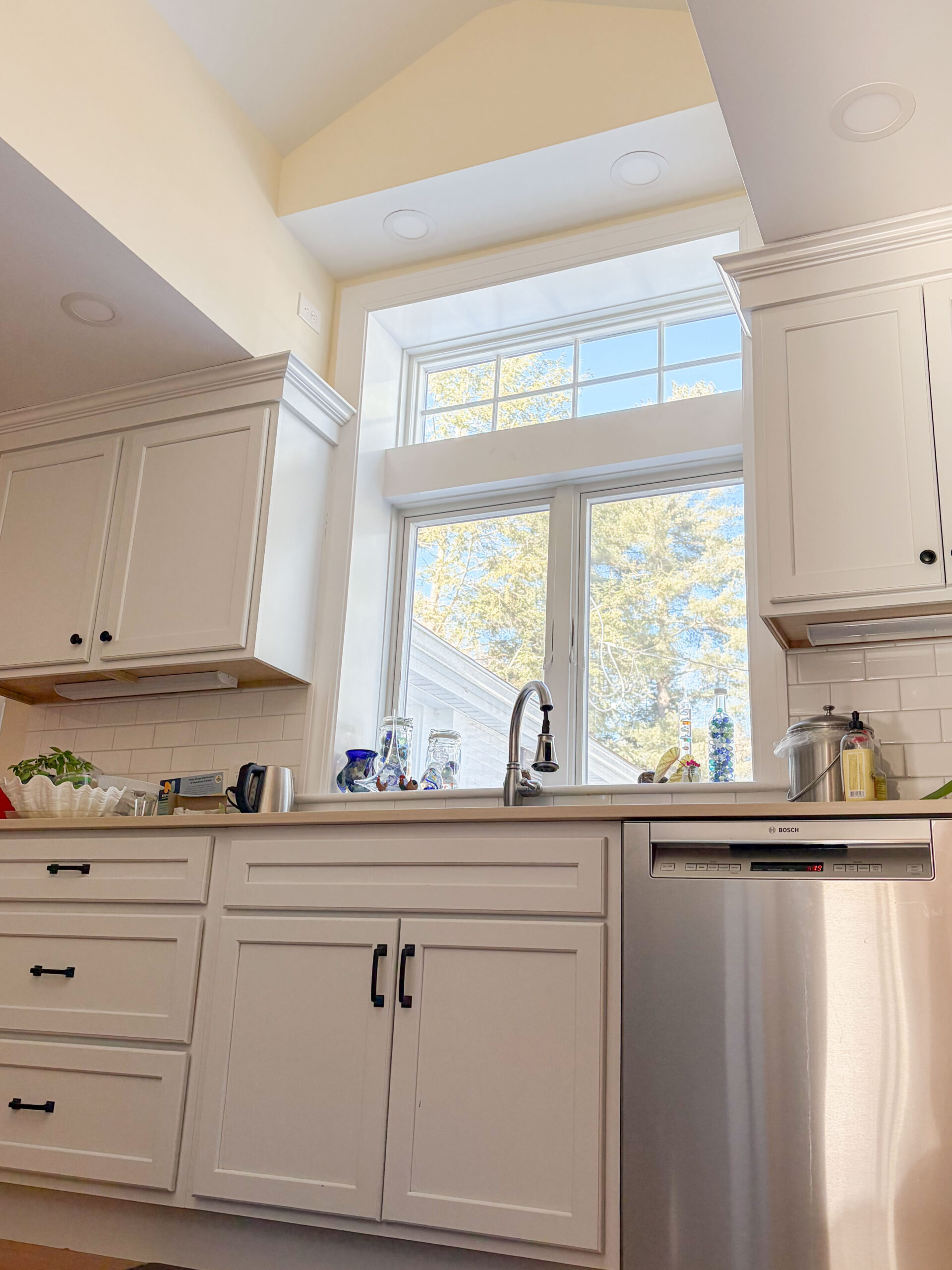 View from inside showing sink and cabinets and window